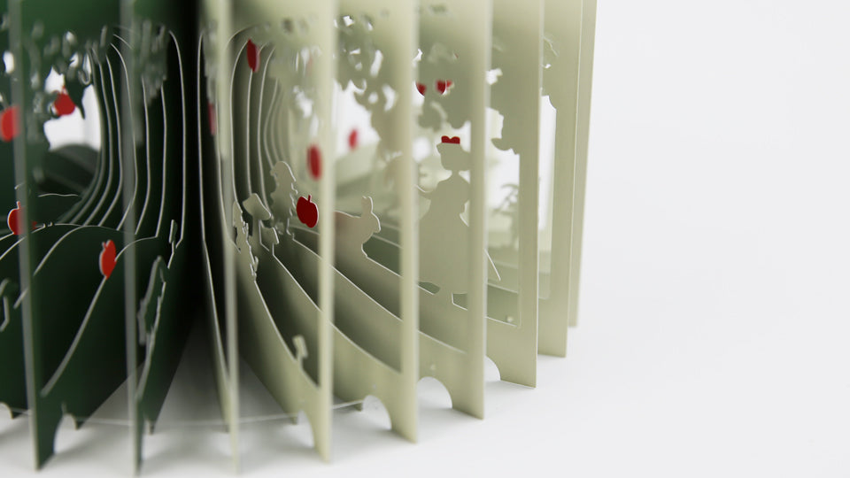 SNOW WHITE 360°BOOK by Yusuke Oono, published by Seigenha Art Publishing in 2016. Carefully crafted paper art book with a 360-degree panoramic scene of layered silhouettes, showing Snow White’s story.