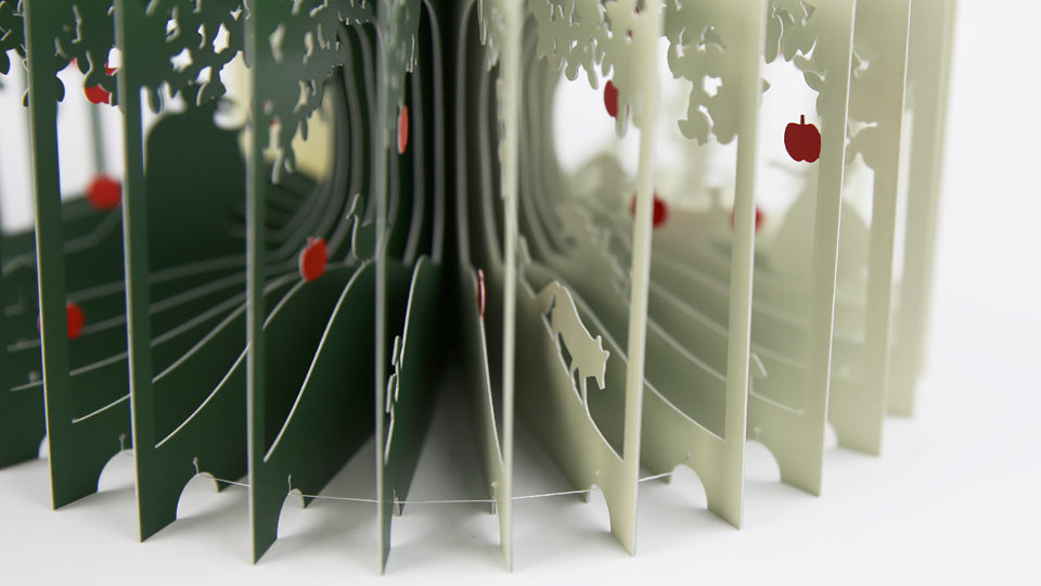SNOW WHITE 360°BOOK by Yusuke Oono, published by Seigenha Art Publishing in 2016. Carefully crafted paper art book with a 360-degree panoramic scene of layered silhouettes, showing Snow White’s story.