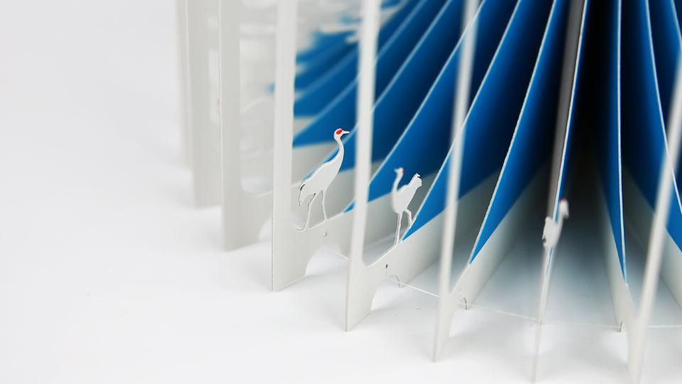 MOUNT FUJI 360°BOOK by Yusuke Oono, published by Seigenha Art Publishing in 2015. Carefully crafted paper art book with a 360-degree panoramic scene of layered silhouettes, showing Mount Fuji.