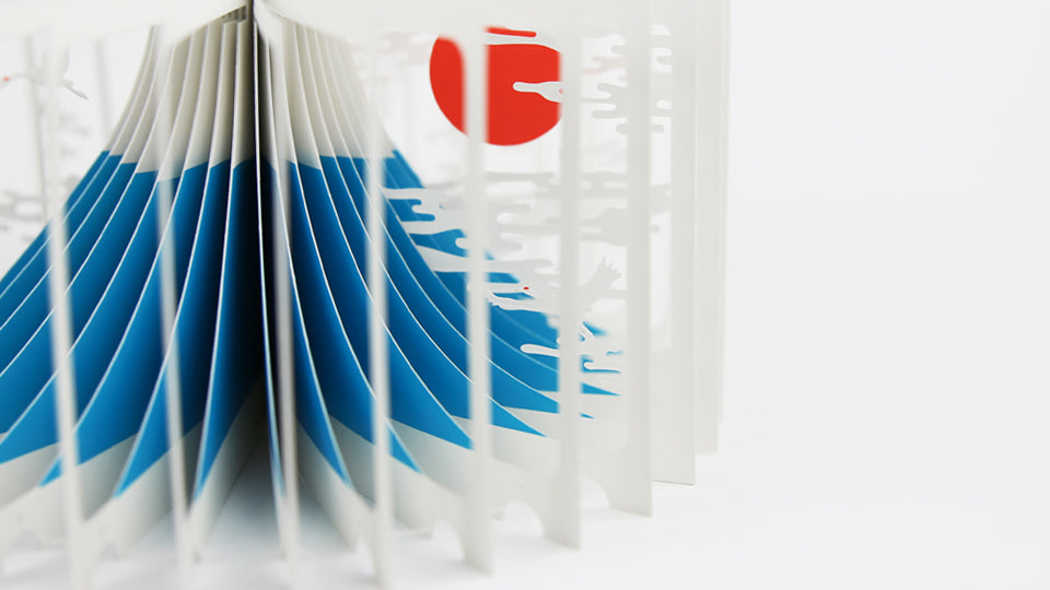 MOUNT FUJI 360°BOOK by Yusuke Oono, published by Seigenha Art Publishing in 2015. Carefully crafted paper art book with a 360-degree panoramic scene of layered silhouettes, showing Mount Fuji.
