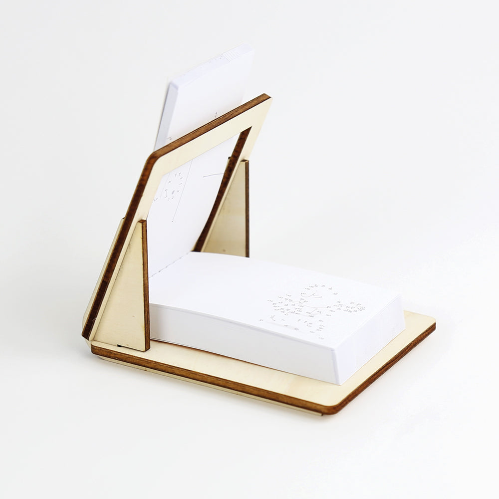 FLIPBOKU HOLDER - a practical tool that will enrich your experience with our interactive flip books Molecularis, Blanko and Dots & Lines. It gives you some more freedom of movement while coloring, drawing, or connecting the dots.